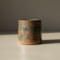 Tazza Lichene su piano cemento, sfondo grigio, luce naturale trasversale